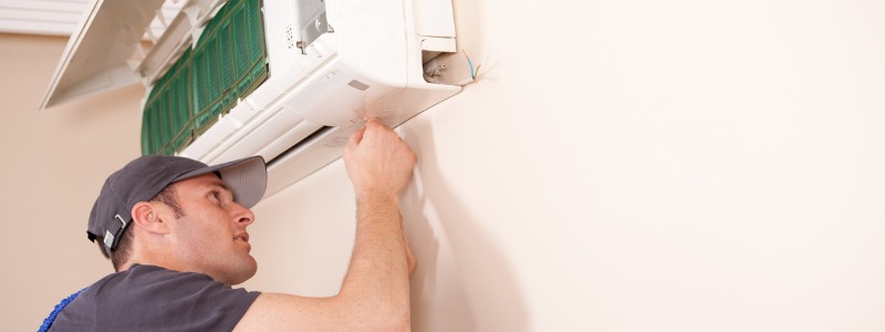 HVAC technician installing a new ductless AC unit in an Ohio home