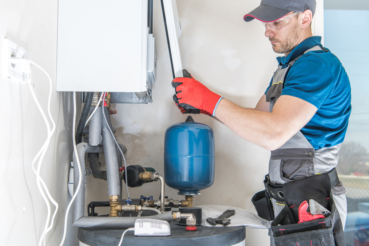 HVAC technician installing a residential boiler