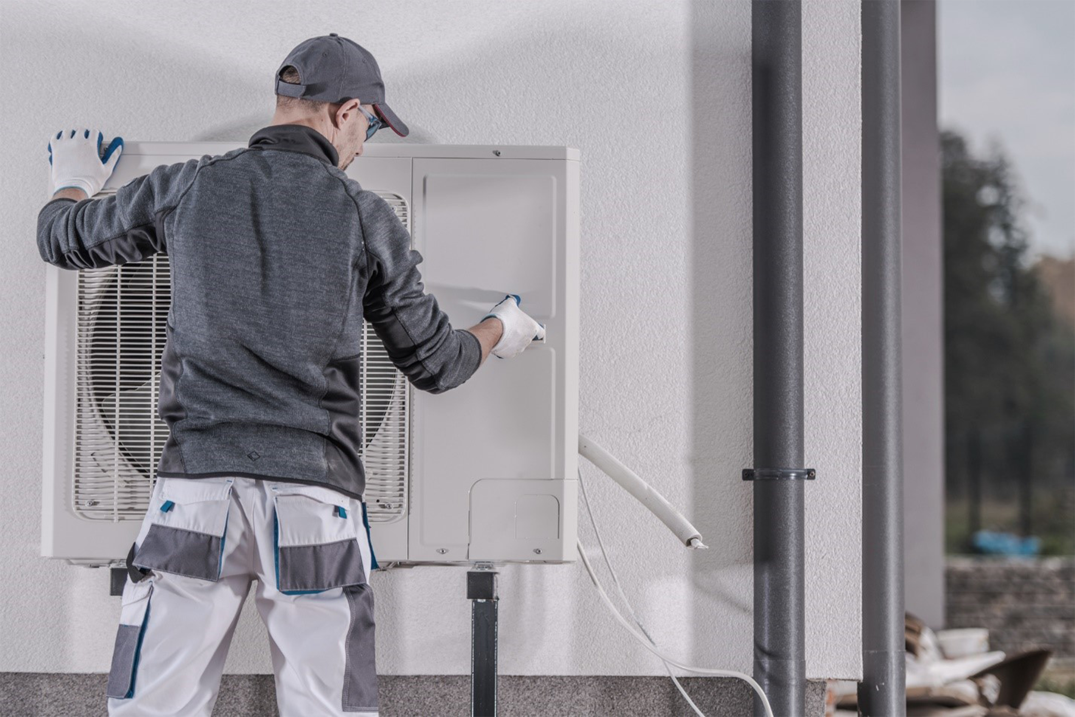 Technician replacing a mounted residential heat pump