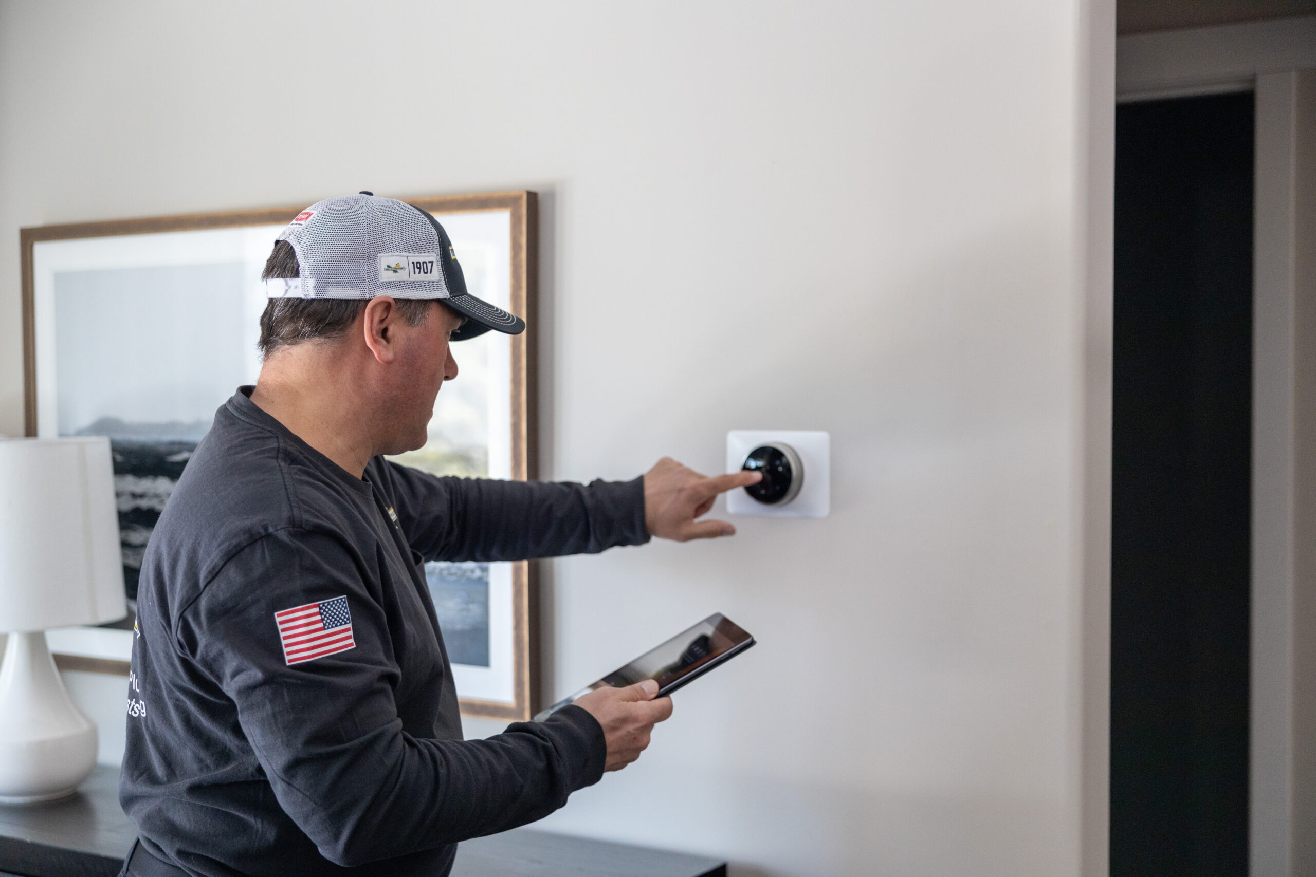 Verne & Ellsworth Hann technician installing a new thermostat in an Ohio home