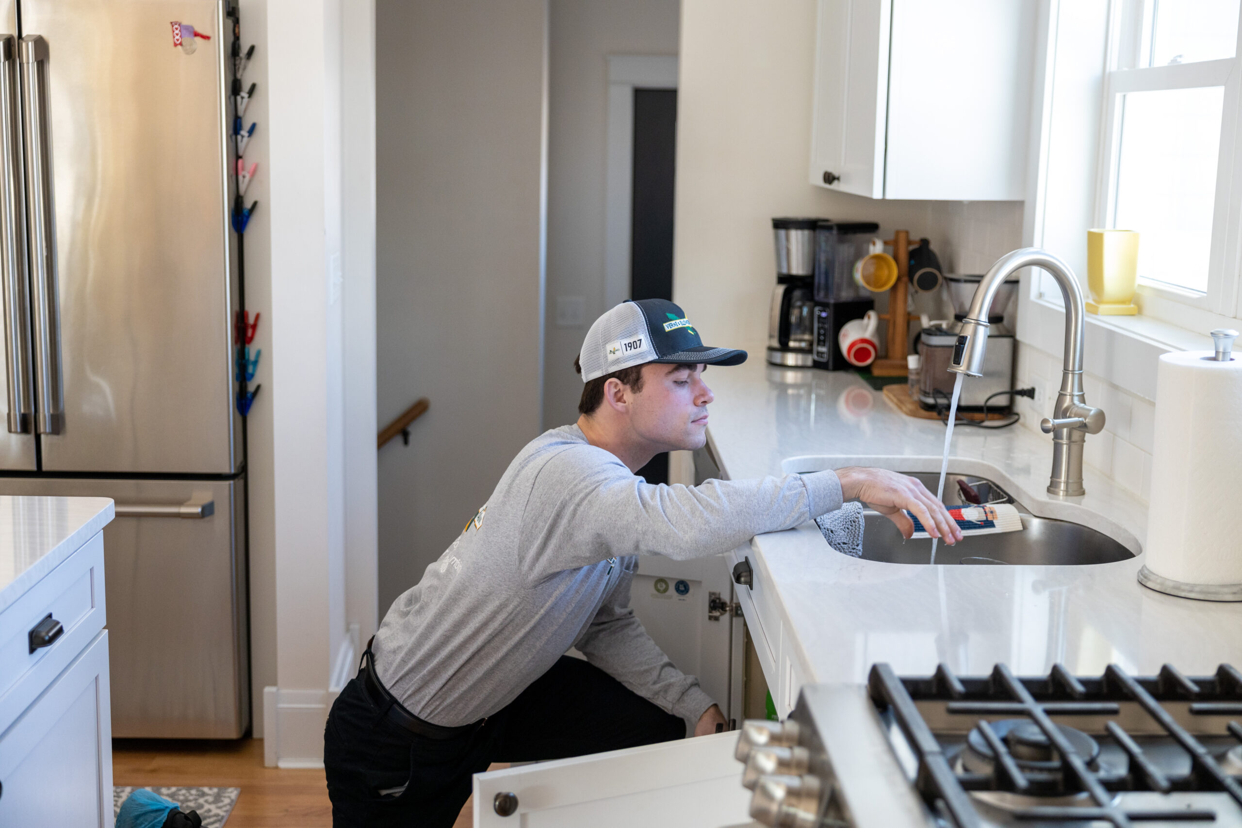 Verne & Ellsworth Hann technician fixing the kitchen plumbing of an Ohio home