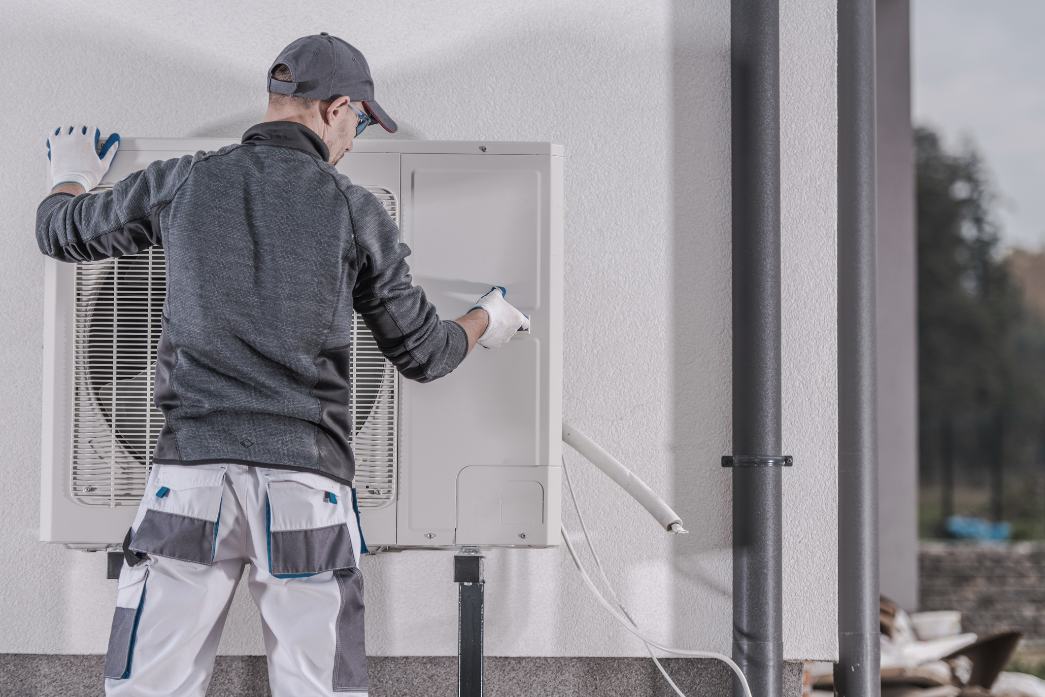 HVAC technician repairing a residential heat pump