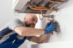 Technician repairing a broken boiler